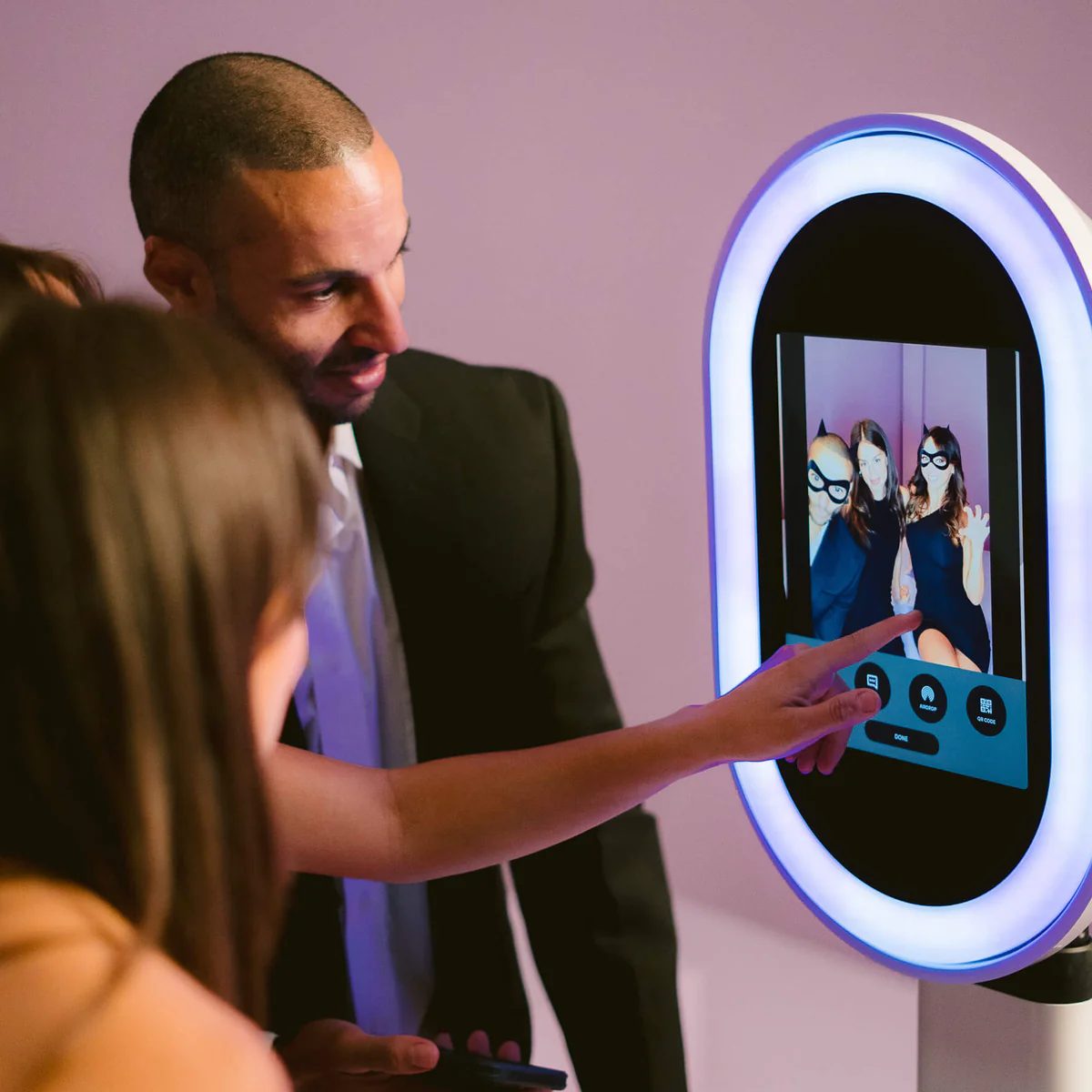 Attendant helping guests with the Captivent photobooth